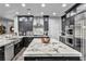 Modern kitchen featuring stainless steel appliances, white marble counters and black cabinets at 5805 Cabo San Lucas Ave, Las Vegas, NV 89131