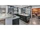 Kitchen featuring stainless steel appliances, white marble counters, black cabinets and wood floors at 5805 Cabo San Lucas Ave, Las Vegas, NV 89131
