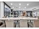 Bright kitchen featuring stainless steel appliances, white marble counters and black cabinets at 5805 Cabo San Lucas Ave, Las Vegas, NV 89131