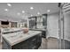 Modern kitchen with marble counters, stainless steel appliances and black cabinets at 5805 Cabo San Lucas Ave, Las Vegas, NV 89131