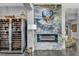 Elegant living room boasts a striking fireplace with stone decor, a wine fridge, and staircase access at 5805 Cabo San Lucas Ave, Las Vegas, NV 89131