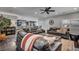 Spacious living room with dark leather sofas, ceiling fan and shutters at 5805 Cabo San Lucas Ave, Las Vegas, NV 89131