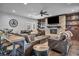 Living room features a stone fireplace, wood mantel, built-in shelves, and leather sofas at 5805 Cabo San Lucas Ave, Las Vegas, NV 89131