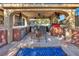 Covered outdoor kitchen and grill area, complete with bar seating and modern appliances for alfresco dining at 5805 Cabo San Lucas Ave, Las Vegas, NV 89131