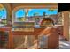 Outdoor kitchen features a grill, pizza oven, and stainless steel cabinets for entertaining in style at 5805 Cabo San Lucas Ave, Las Vegas, NV 89131