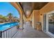 Outdoor living space featuring a covered patio, pool, and lush desert landscaping at 5805 Cabo San Lucas Ave, Las Vegas, NV 89131
