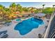 Aerial view of the backyard featuring a sparkling pool, hot tub, and shaded bar area surrounded by lush, mature landscaping at 5805 Cabo San Lucas Ave, Las Vegas, NV 89131