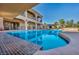 Backyard pool with a sun shelf and patio, complemented by a two-story home with a covered patio and balcony at 5805 Cabo San Lucas Ave, Las Vegas, NV 89131