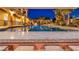 Relaxing outdoor pool and living space with a covered patio, offering a luxurious backyard retreat at 5805 Cabo San Lucas Ave, Las Vegas, NV 89131