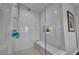 Modern walk-in shower with white subway tile, a built-in bench, and glass enclosure at 5805 Cabo San Lucas Ave, Las Vegas, NV 89131