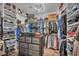 Large walk-in closet with built-in shelving, hanging racks, and a central dresser at 5805 Cabo San Lucas Ave, Las Vegas, NV 89131