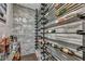 Modern wine cellar with sleek metal wine racks and gray stone walls at 5805 Cabo San Lucas Ave, Las Vegas, NV 89131