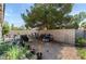 Backyard featuring a gravel area, bordered by a brick fence and mature shade trees at 5914 Rose Sage St, North Las Vegas, NV 89031