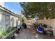 Cozy backyard featuring a gravel area, bordered by a brick fence and mature shade trees at 5914 Rose Sage St, North Las Vegas, NV 89031