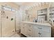 Bathroom featuring double sinks, vanity, and a separate glass enclosed shower at 5914 Rose Sage St, North Las Vegas, NV 89031