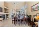 Open dining area with tile floors, high ceilings, and views of the kitchen and living room at 5914 Rose Sage St, North Las Vegas, NV 89031