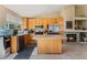 Well-lit kitchen with a center island, tile flooring, and stainless steel appliances at 5914 Rose Sage St, North Las Vegas, NV 89031