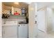 Laundry room featuring a washer, dryer, and storage shelves at 5914 Rose Sage St, North Las Vegas, NV 89031