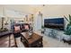 Inviting living room with tile floors, neutral walls, open layout and comfortable furnishings at 5914 Rose Sage St, North Las Vegas, NV 89031