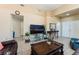 Cozy living room with tile floors, comfortable seating, and a view of the front entrance at 5914 Rose Sage St, North Las Vegas, NV 89031