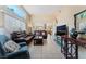 Spacious living room with tile flooring, large windows, and comfortable seating at 5914 Rose Sage St, North Las Vegas, NV 89031