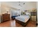 Cozy main bedroom features a ceiling fan, natural light, and wood laminate flooring at 5914 Rose Sage St, North Las Vegas, NV 89031