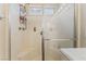 Enclosed shower with seating and a small window providing natural light at 5914 Rose Sage St, North Las Vegas, NV 89031