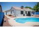 Backyard pool is complemented by a covered patio and landscaped surroundings, creating a private retreat at 6249 Halehaven Dr, Las Vegas, NV 89110