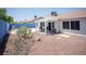 Charming backyard featuring a covered patio, gravel landscaping, and a refreshing swimming pool at 6249 Halehaven Dr, Las Vegas, NV 89110