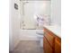 Bright bathroom with a tiled shower-tub, toilet, and a wooden vanity offering storage and functionality at 6249 Halehaven Dr, Las Vegas, NV 89110