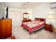 Cozy bedroom with warm tones, a comfortable bed, and classic wooden furniture at 6249 Halehaven Dr, Las Vegas, NV 89110