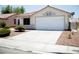 A well-maintained concrete driveway that leads to a two-car garage, surrounded by desert landscaping at 6249 Halehaven Dr, Las Vegas, NV 89110