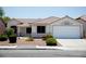 Charming single-story home featuring a red tile roof, desert landscaping, and a two-car garage at 6249 Halehaven Dr, Las Vegas, NV 89110