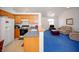 Open floorplan with views of living room and dining area from the kitchen with wood cabinetry at 6249 Halehaven Dr, Las Vegas, NV 89110