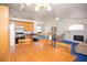 Open-concept living room and kitchen area featuring hardwood cabinets and modern appliances at 6249 Halehaven Dr, Las Vegas, NV 89110