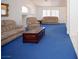 Bright living room with vaulted ceilings, fireplace, and plush blue carpet at 6249 Halehaven Dr, Las Vegas, NV 89110