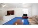 Cozy living area featuring vaulted ceilings, blue carpet, and a built-in bookcase at 6249 Halehaven Dr, Las Vegas, NV 89110