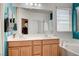 Bathroom featuring double sinks and tub with shower at 635 Taliput Palm Pl, Henderson, NV 89011
