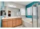 Bathroom featuring double sinks, bathtub, and tiled shower at 635 Taliput Palm Pl, Henderson, NV 89011
