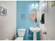 Charming half-bathroom features a pedestal sink, modern fixtures, and stylish blue walls at 635 Taliput Palm Pl, Henderson, NV 89011