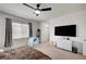 Bright bedroom features a ceiling fan, window, closet, and carpeted floor at 635 Taliput Palm Pl, Henderson, NV 89011