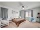 Inviting bedroom with a ceiling fan, large window, and comfortable decor at 635 Taliput Palm Pl, Henderson, NV 89011