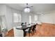 Well-lit dining area featuring a stylish chandelier, dining table, and seamless flow to the living room at 635 Taliput Palm Pl, Henderson, NV 89011