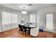 Bright dining area with stylish chandelier, dark wood table, and access to the backyard at 635 Taliput Palm Pl, Henderson, NV 89011
