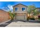 Charming two-story home with a two-car garage, desert landscaping, and a well-maintained front yard at 635 Taliput Palm Pl, Henderson, NV 89011