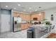 Bright kitchen boasts stainless steel appliances, granite countertops, and ample cabinet space at 635 Taliput Palm Pl, Henderson, NV 89011