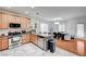 Open kitchen flows into the dining area with stainless steel appliances and granite countertops at 635 Taliput Palm Pl, Henderson, NV 89011