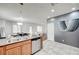 Spacious kitchen with granite countertops, stainless dishwasher, and open layout to the living areas at 635 Taliput Palm Pl, Henderson, NV 89011