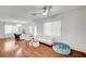Bright living room with modern flooring, white walls, and a contemporary ceiling fan at 635 Taliput Palm Pl, Henderson, NV 89011
