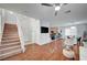 Open-concept living space with stairs, wood floors, and seamless flow to kitchen and dining area at 635 Taliput Palm Pl, Henderson, NV 89011